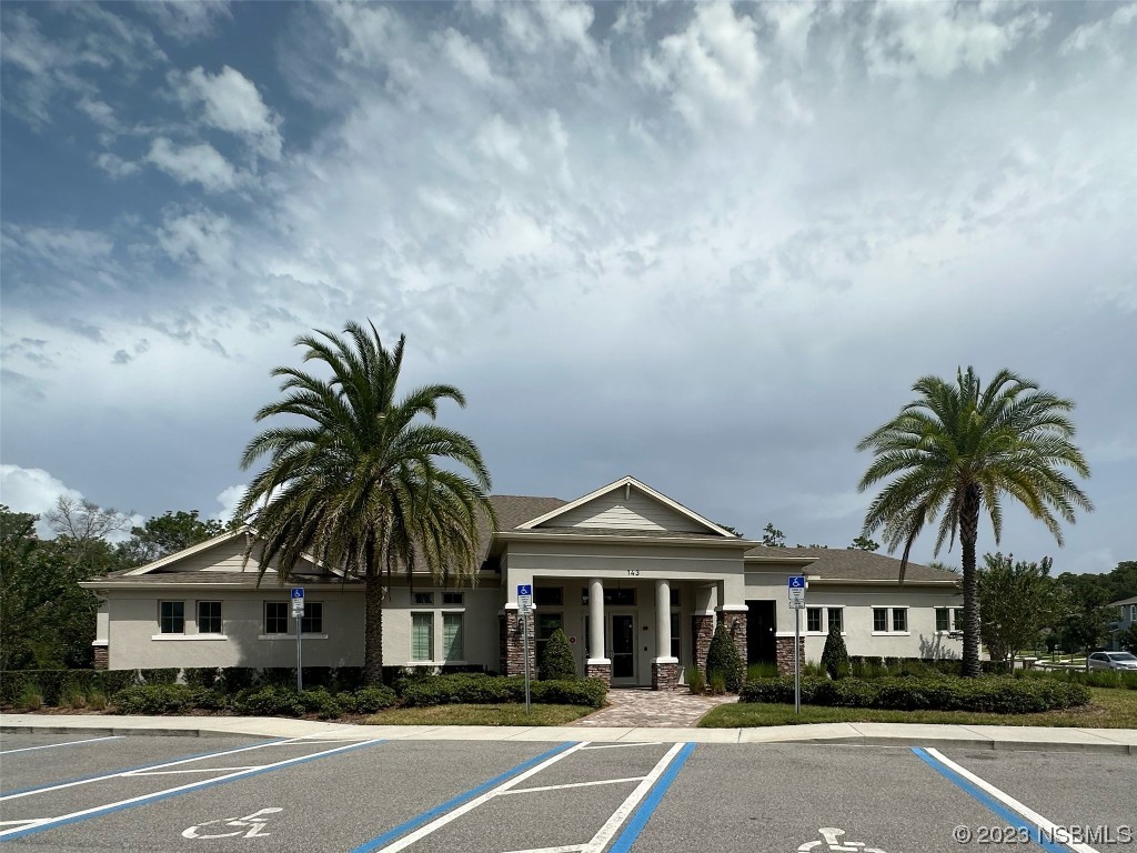 354 Camilla Road DeLand, FL 32724 - Photo 48 of 57 a front view of a house with a garden and a garage