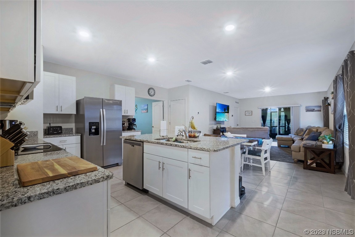 354 Camilla Road DeLand, FL 32724 - Photo 7 of 57 a kitchen with a sink a counter top space appliances and cabinets
