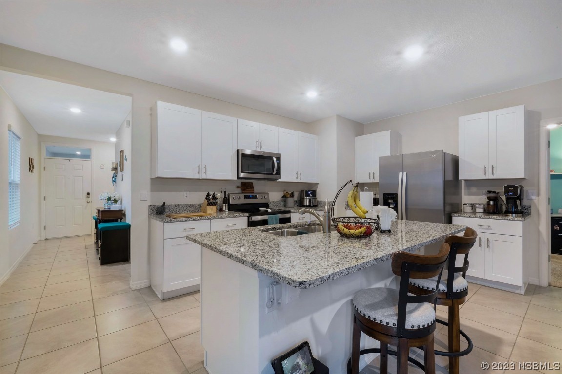 354 Camilla Road DeLand, FL 32724 - Photo 9 of 57 a kitchen with refrigerator and cabinets