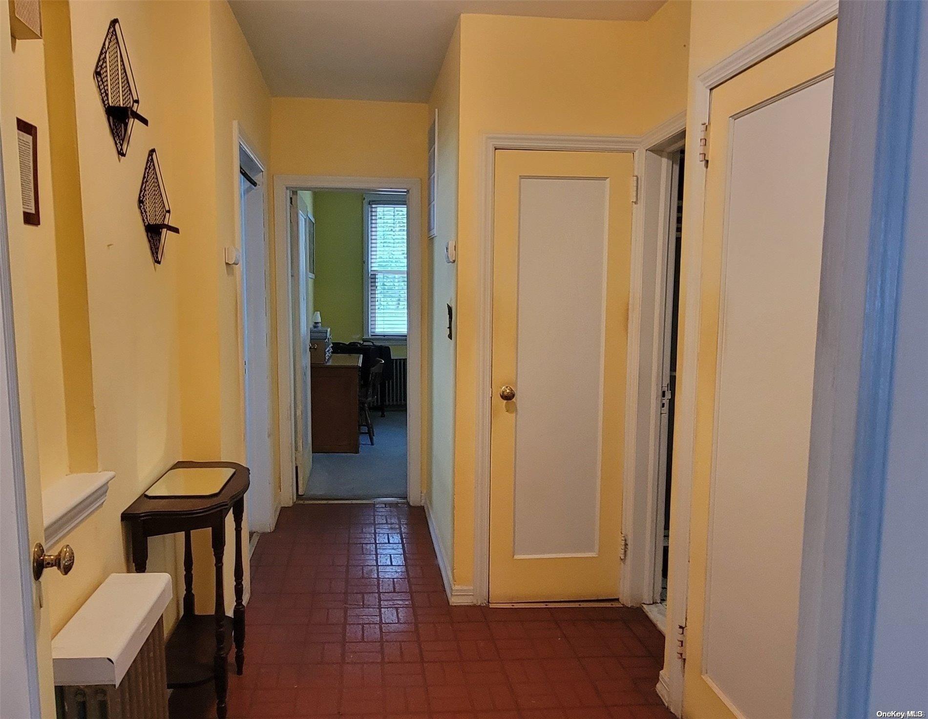 138 Hewlett Avenue Merrick, NY 11566 - Photo 16 of 35 a view of a hallway with wooden floor and furniture
