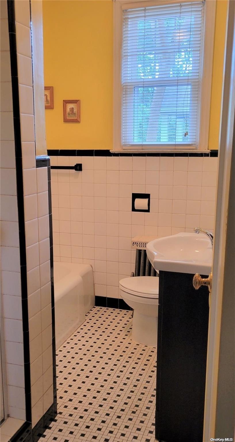 138 Hewlett Avenue Merrick, NY 11566 - Photo 17 of 35 a bathroom with a sink a toilet and a shower