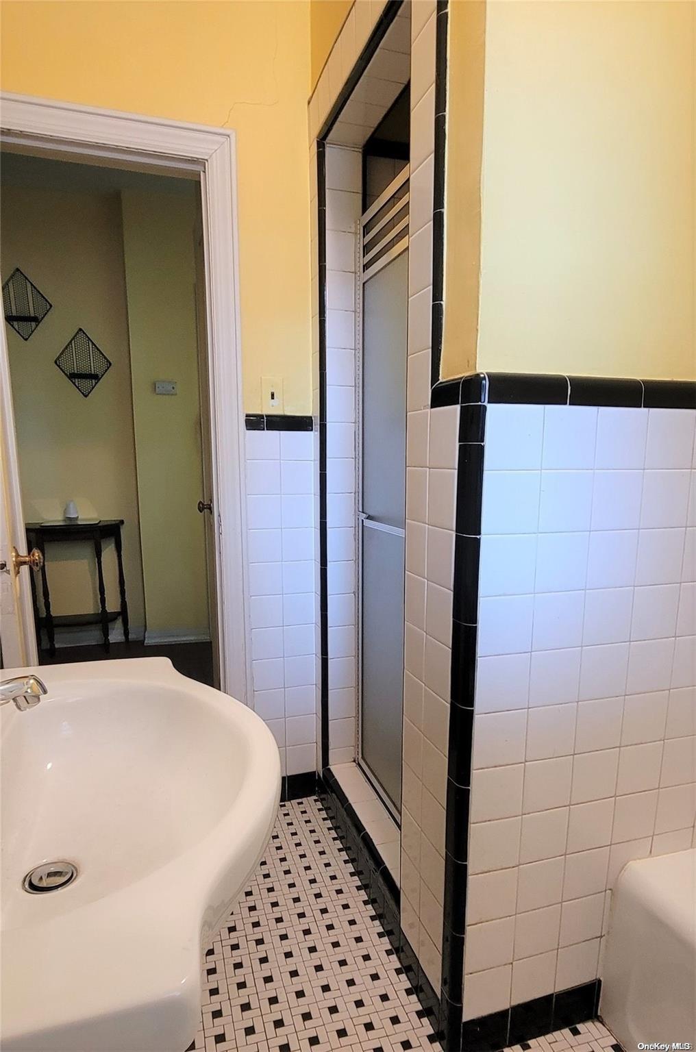 138 Hewlett Avenue Merrick, NY 11566 - Photo 19 of 35 a bathroom with a sink and a shower