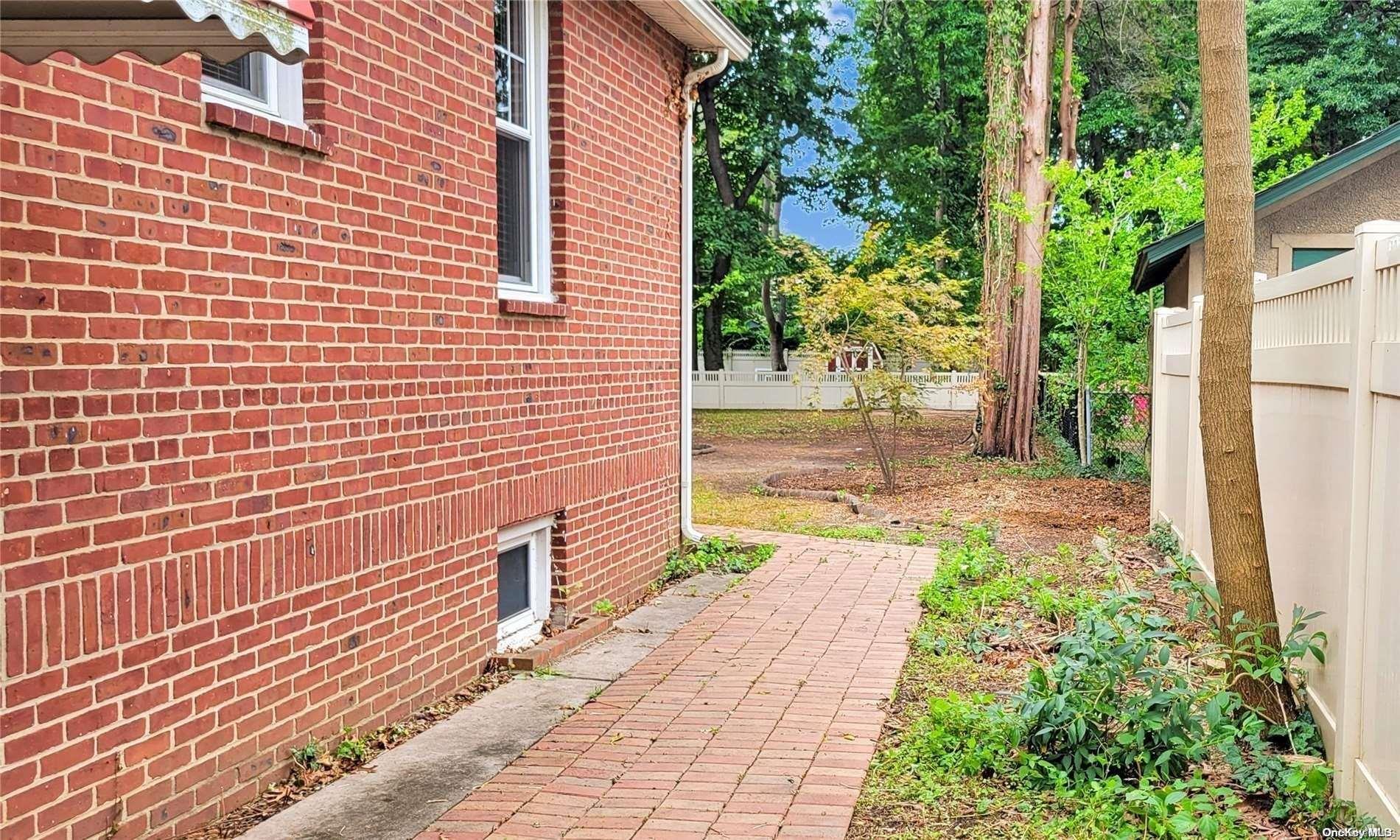 138 Hewlett Avenue Merrick, NY 11566 - Photo 31 of 35 a view of a pathway with a house
