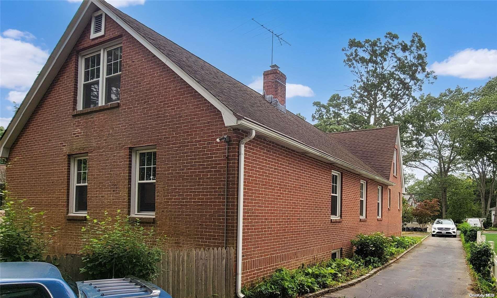 138 Hewlett Avenue Merrick, NY 11566 - Photo 33 of 35 a front view of a house with trees