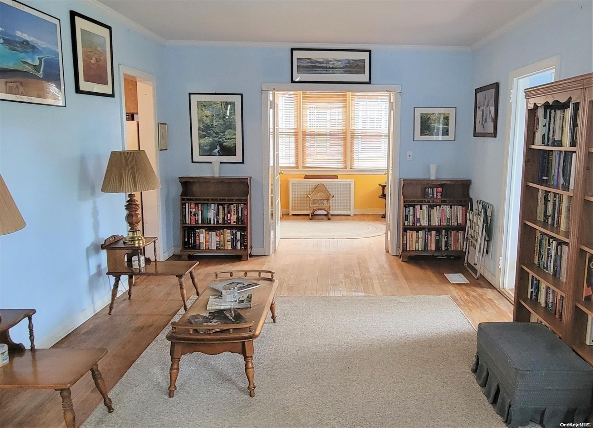 138 Hewlett Avenue Merrick, NY 11566 - Photo 6 of 35 a living room with furniture and a book shelf