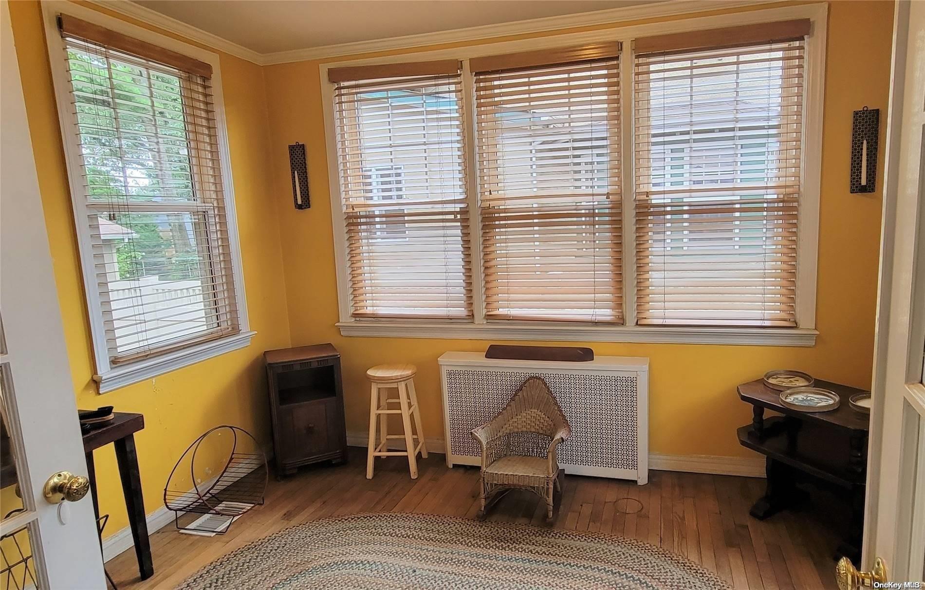 138 Hewlett Avenue Merrick, NY 11566 - Photo 9 of 35 a living room with furniture and a window