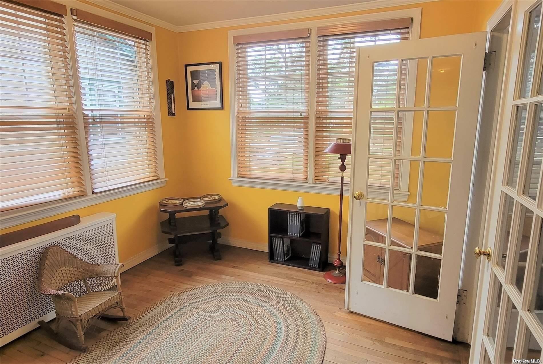 138 Hewlett Avenue Merrick, NY 11566 - Photo 10 of 35 a spacious bedroom with a bed and a window