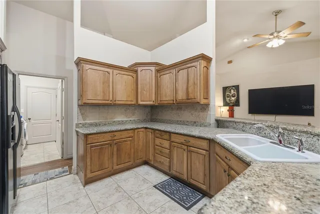 a spacious bathroom with a granite countertop sink a mirror and a