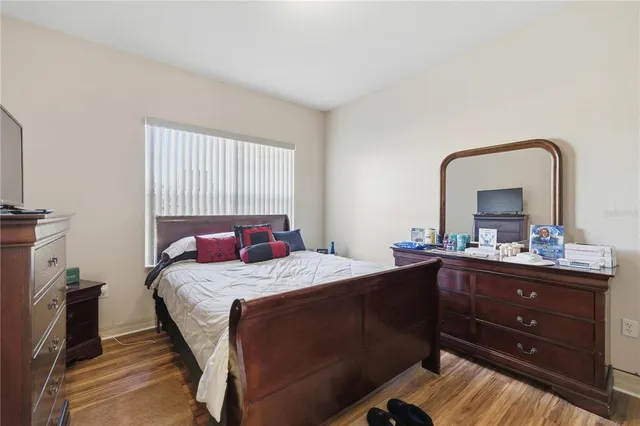 a bedroom with a bed and a dresser