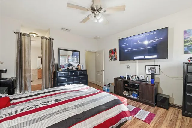 a bedroom with a bed and a flat screen tv
