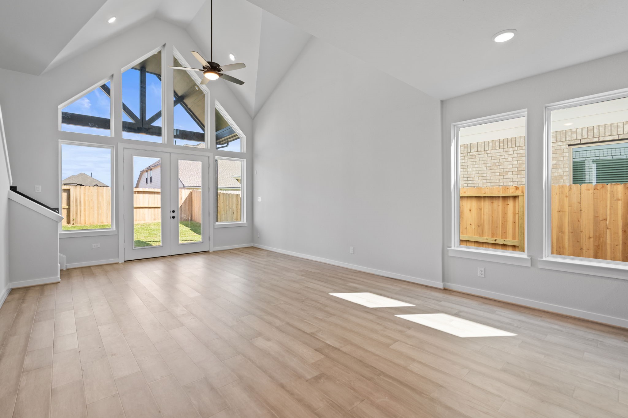 10919 Middle Rdg Drive Missouri City, TX 77459 - Photo 12 of 43 an empty room with wooden floor fan and windows