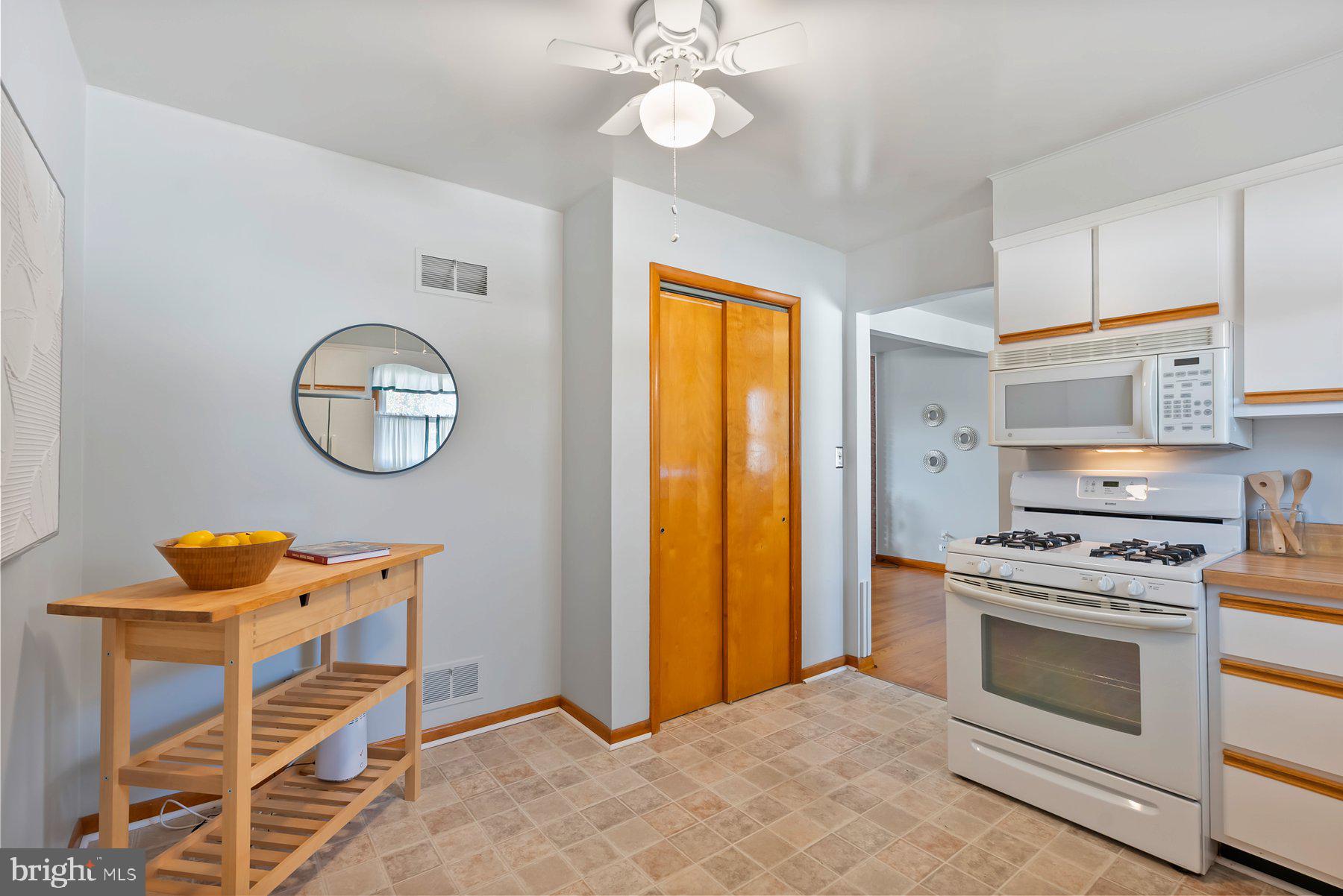 8301 Overmont Road Baltimore, MD 21234 - Photo 12 of 28 a kitchen with stainless steel appliances granite countertop a stove a sink and a refrigerator