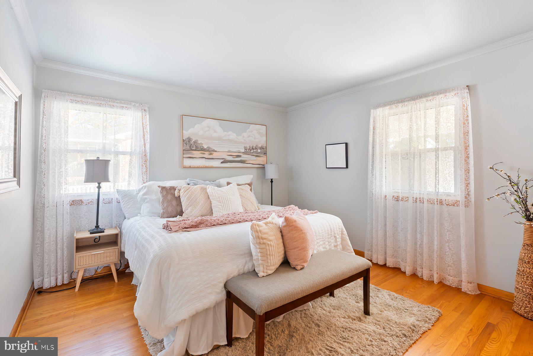 8301 Overmont Road Baltimore, MD 21234 - Photo 13 of 28 a bedroom with a bed and wooden floor