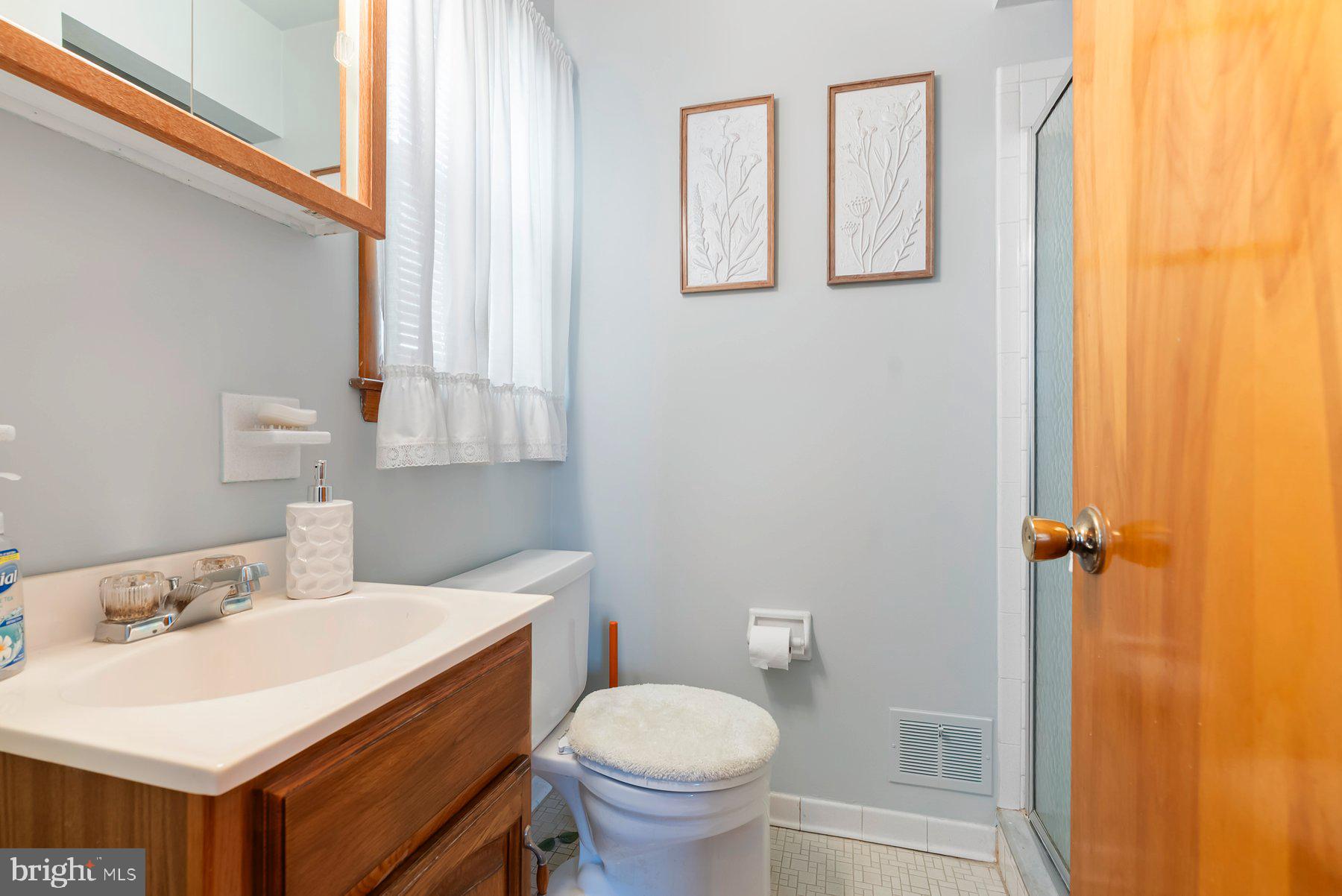 8301 Overmont Road Baltimore, MD 21234 - Photo 15 of 28 a bathroom with a sink a toilet and a mirror