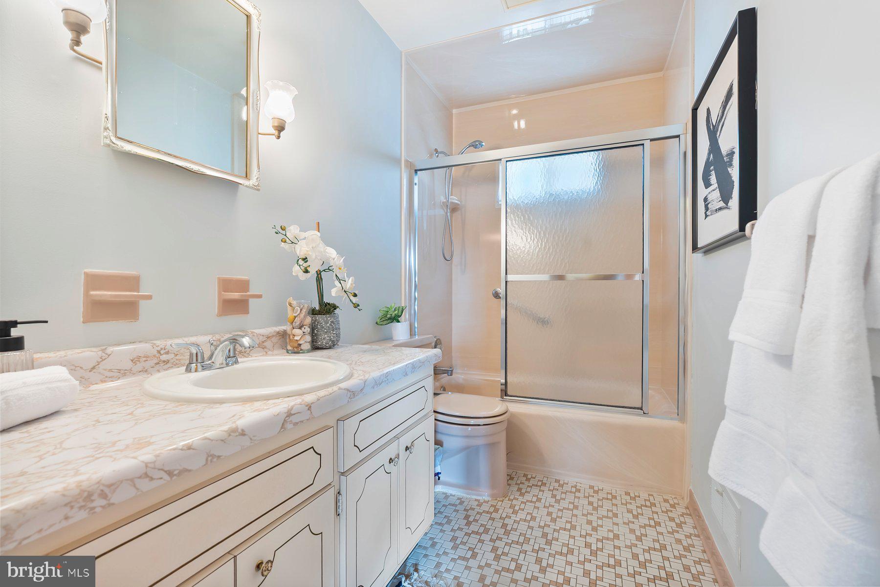 8301 Overmont Road Baltimore, MD 21234 - Photo 18 of 28 a bathroom with a sink a toilet and shower