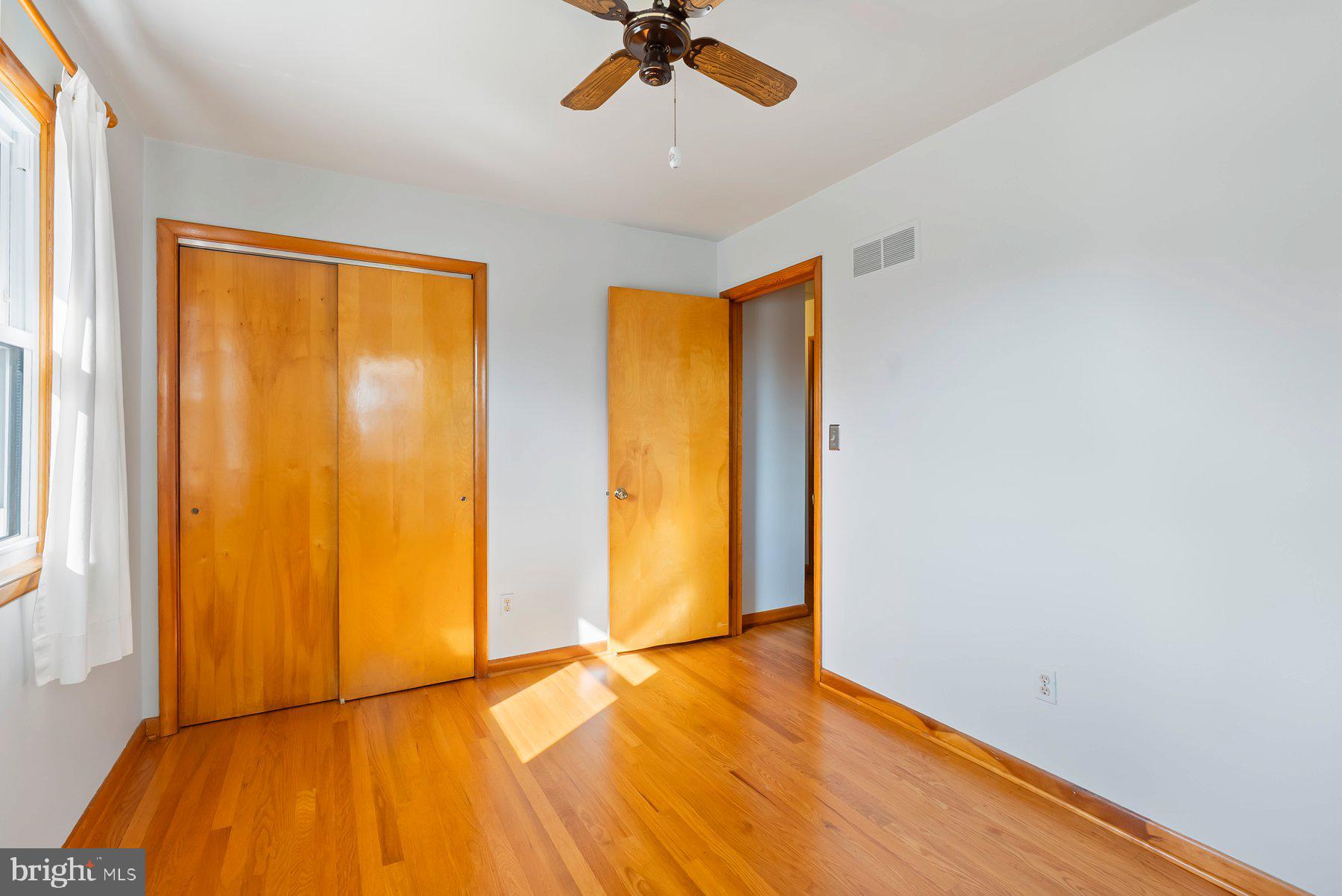 8301 Overmont Road Baltimore, MD 21234 - Photo 20 of 28 wooden floor in an empty room with a window