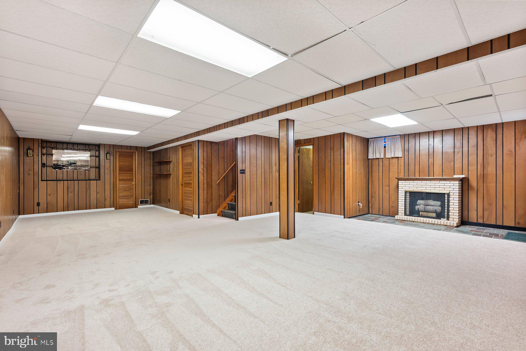 8301 Overmont Road Baltimore, MD 21234 - Photo 21 of 28 a view of an empty room with a fireplace and a window