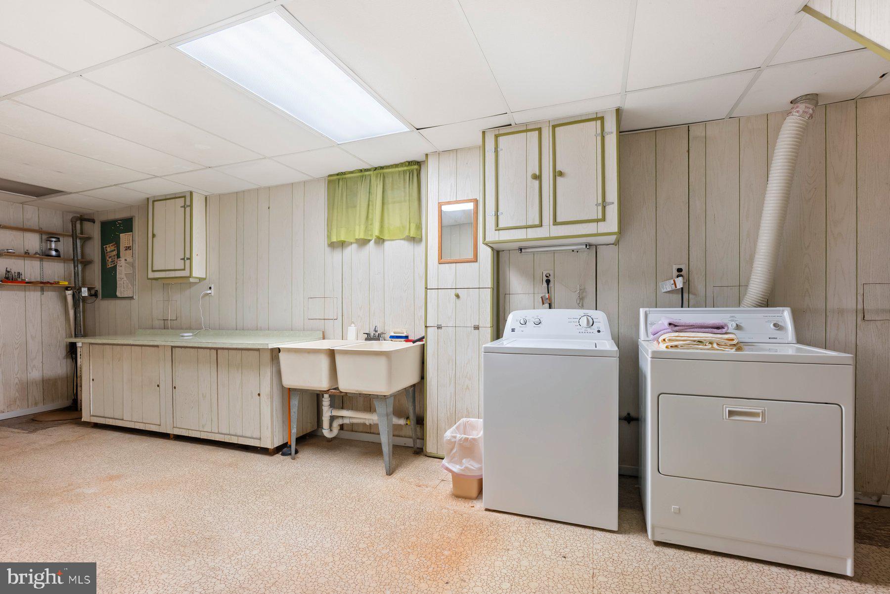 8301 Overmont Road Baltimore, MD 21234 - Photo 25 of 28 a utility room with cabinets washer and dryer