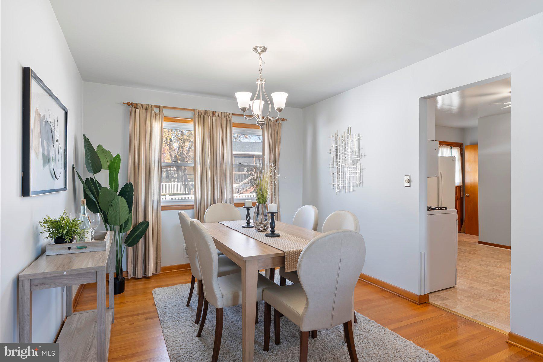 8301 Overmont Road Baltimore, MD 21234 - Photo 8 of 28 a view of a dining room with furniture window and wooden floor