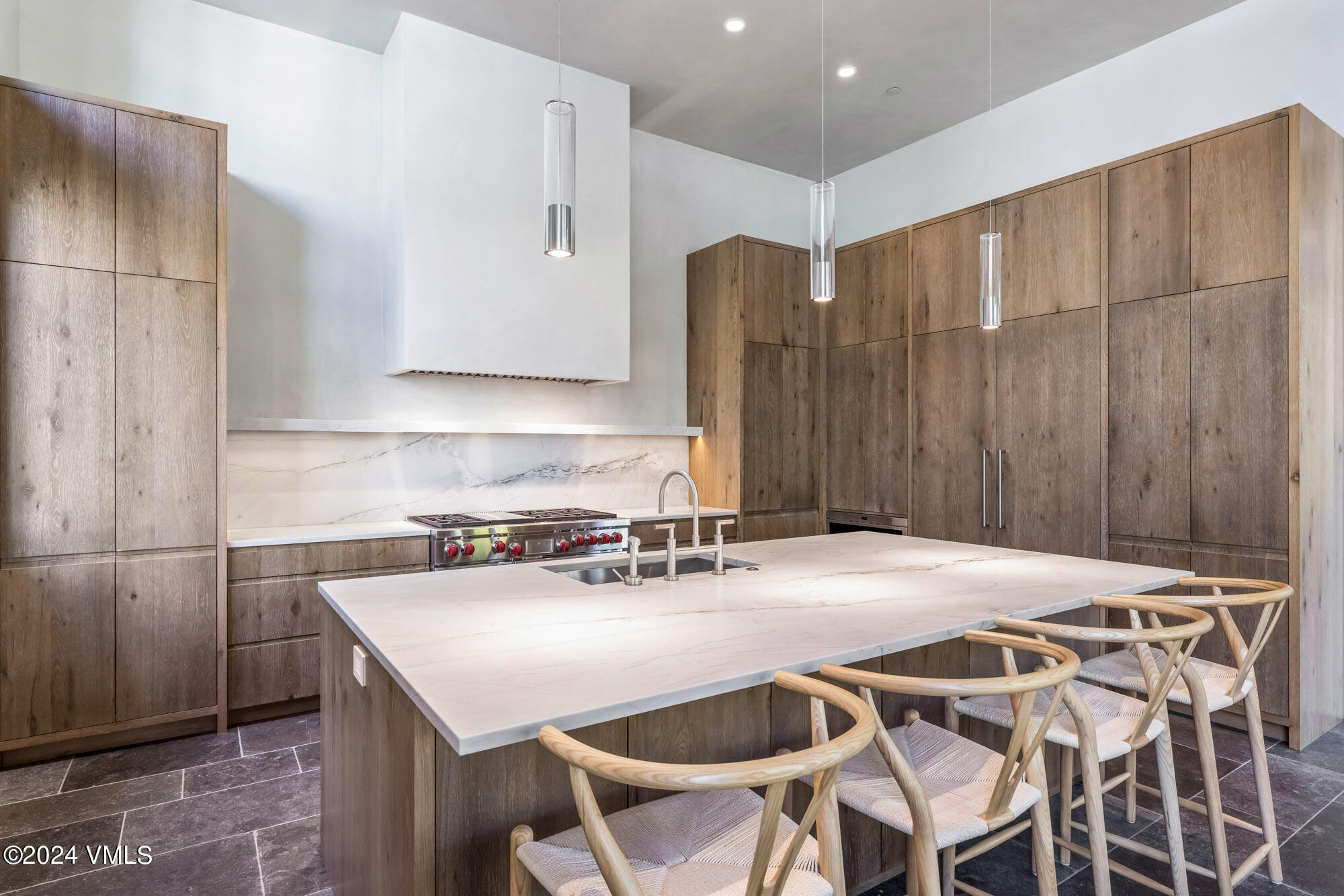 1022 Eagles Nest Circle Vail, CO 81657 - Photo 14 of 41 a kitchen with a table chairs and a refrigerator
