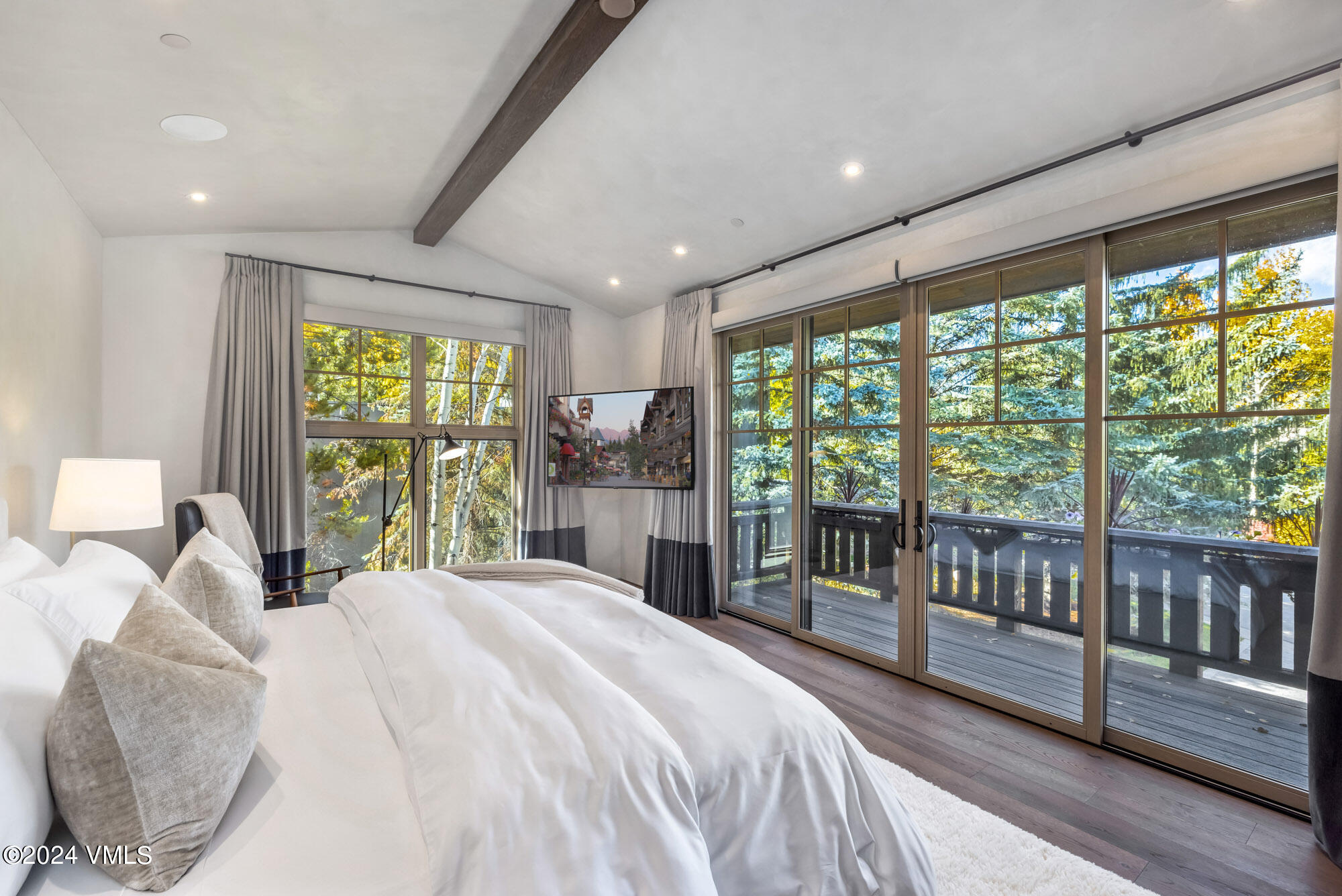 1022 Eagles Nest Circle Vail, CO 81657 - Photo 15 of 41 a bedroom with a large bed and a balcony