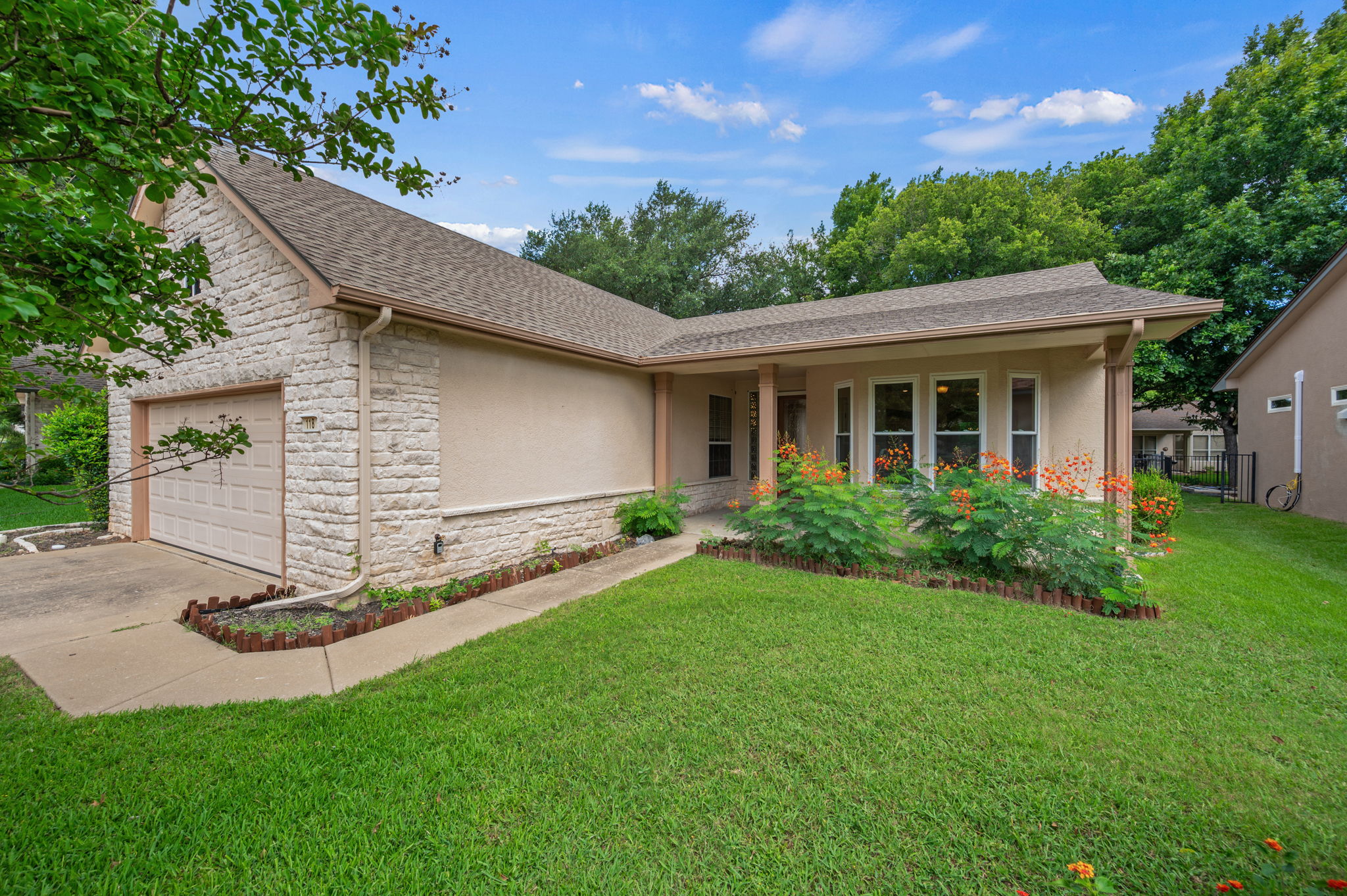 118 Bass Street Georgetown, TX 78633 - Photo 1 of 40 A welcoming stone and stucco facade greets guests, complemented by mature landscaping and a well-maintained lawn.