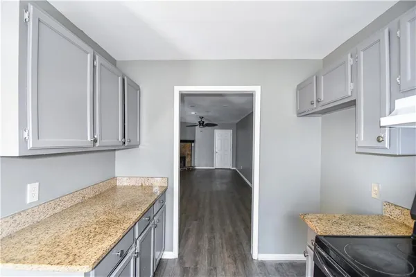 a kitchen with granite countertop wooden cabinets and granite counter tops