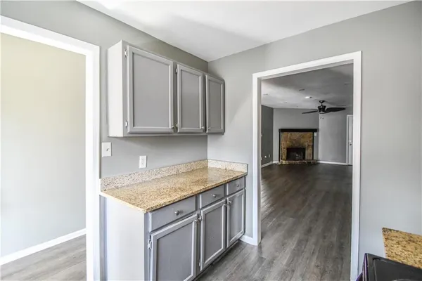 a kitchen with a sink a stove and cabinets