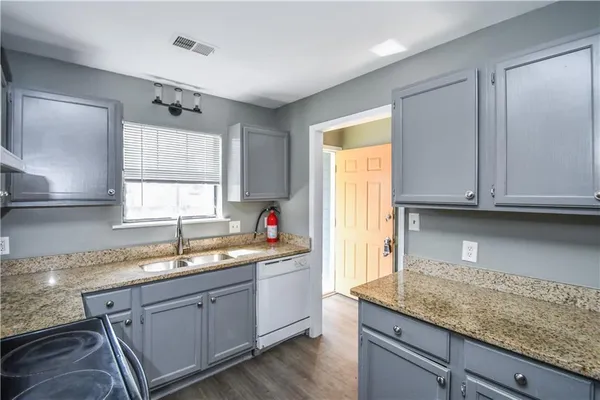 a kitchen with a sink cabinets and window