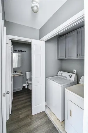 a view of a storage & utility room with closet wooden floor