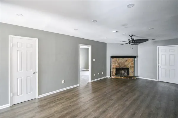 a view of an empty room with a fireplace and a window