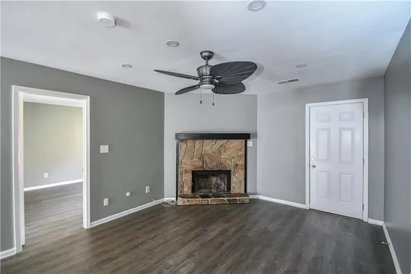 a view of an empty room with a fireplace