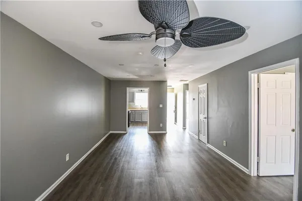 a view of hallway with wooden floor
