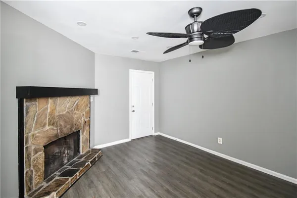 wooden floor in an empty room with a fireplace