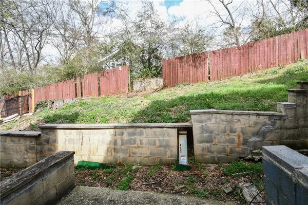 a backyard with potted plants and a wooden fence