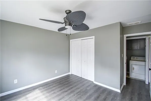 a view of room with a ceiling fan and wooden floor