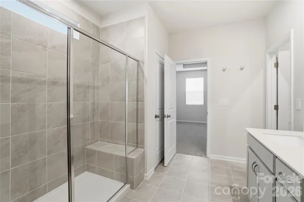 a bathroom with a shower and a sink
