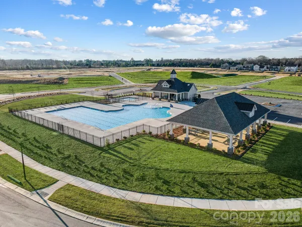 a view of a swimming pool and a yard