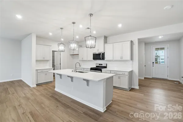 a kitchen with cabinets a sink and appliances
