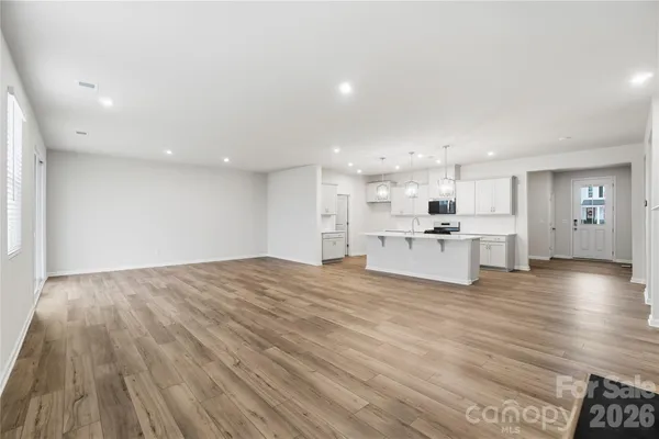 a view of kitchen with wooden floor and windows