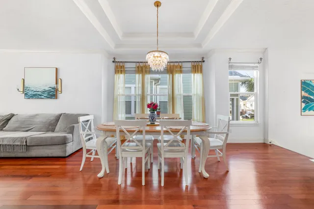 a view of a dining room with furniture wooden floor and chandelier
