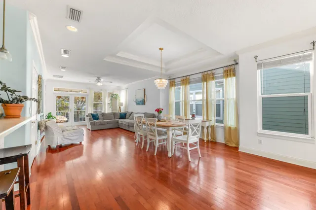 a living room with furniture a wooden floor and a large window