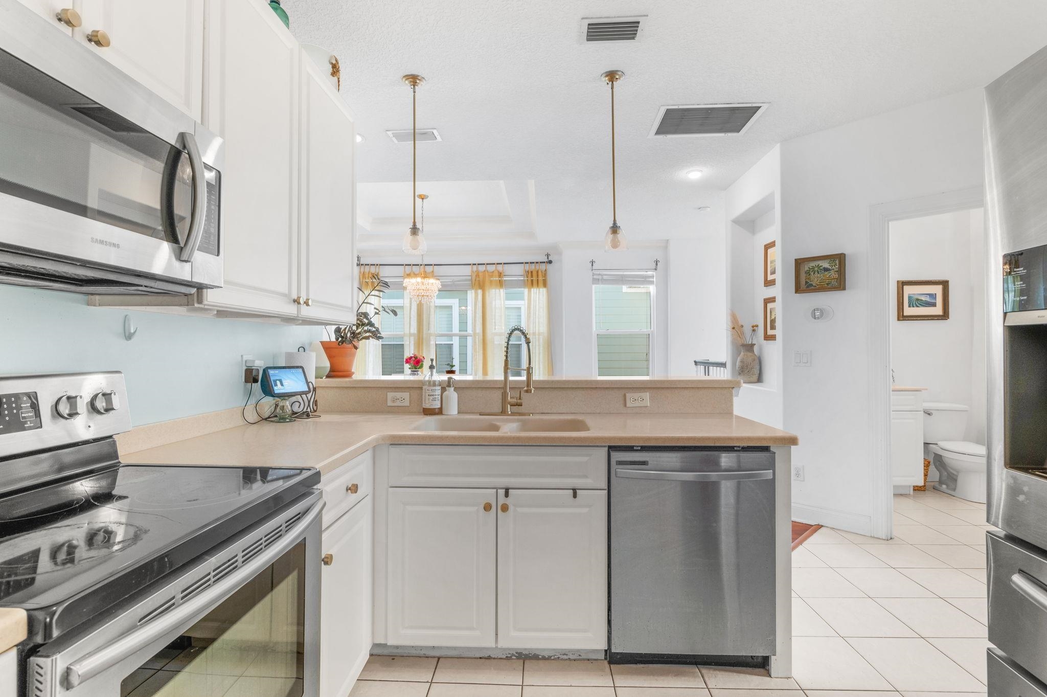 178 Sunset Circle North St. Augustine, FL 32080 - Photo 13 of 45 a kitchen with stainless steel appliances granite countertop a stove a sink and a refrigerator