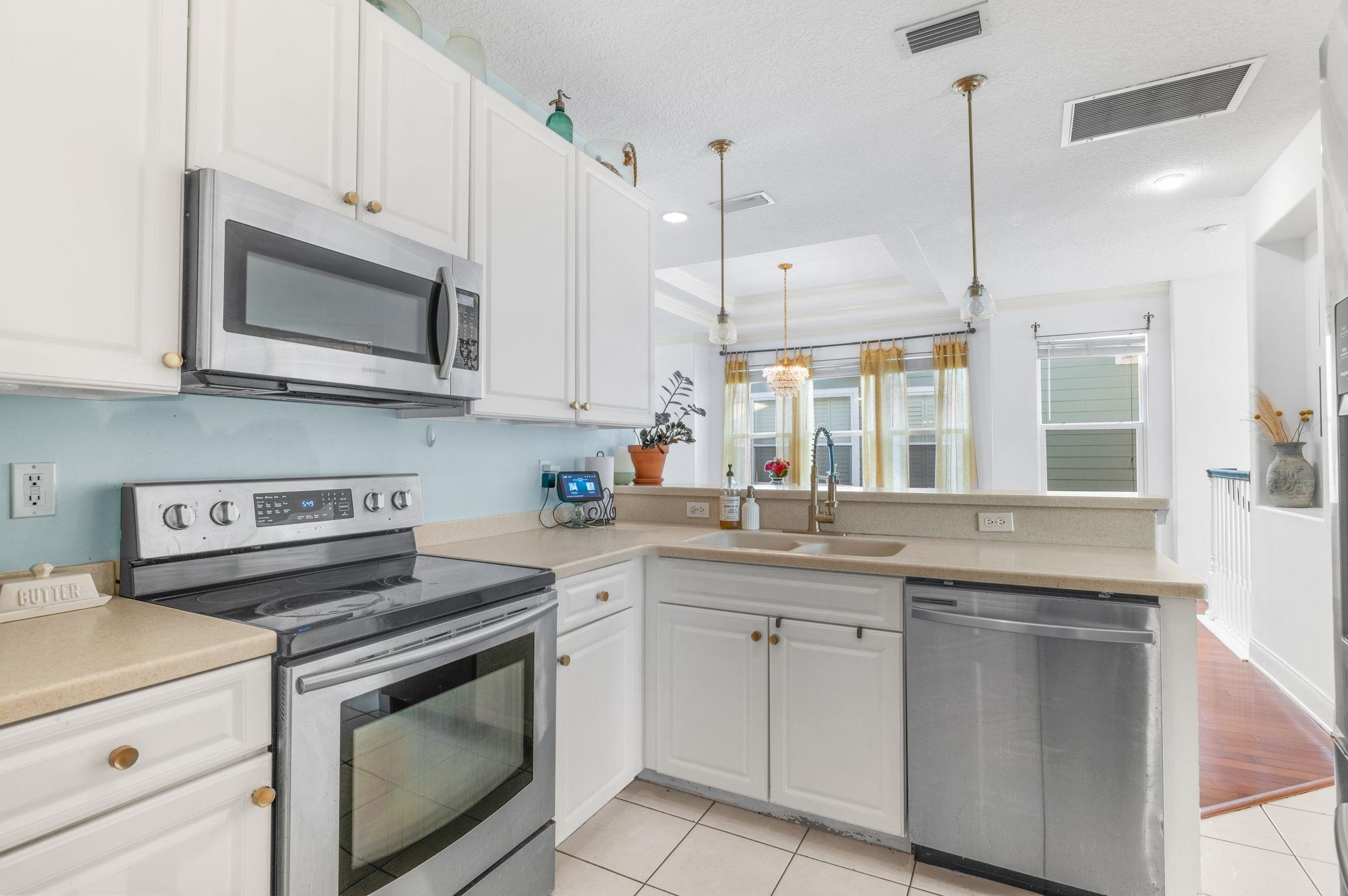 178 Sunset Circle North St. Augustine, FL 32080 - Photo 14 of 45 a kitchen with stainless steel appliances granite countertop a stove a sink and a microwave
