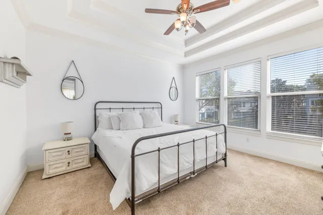 a bedroom with a bed and large window