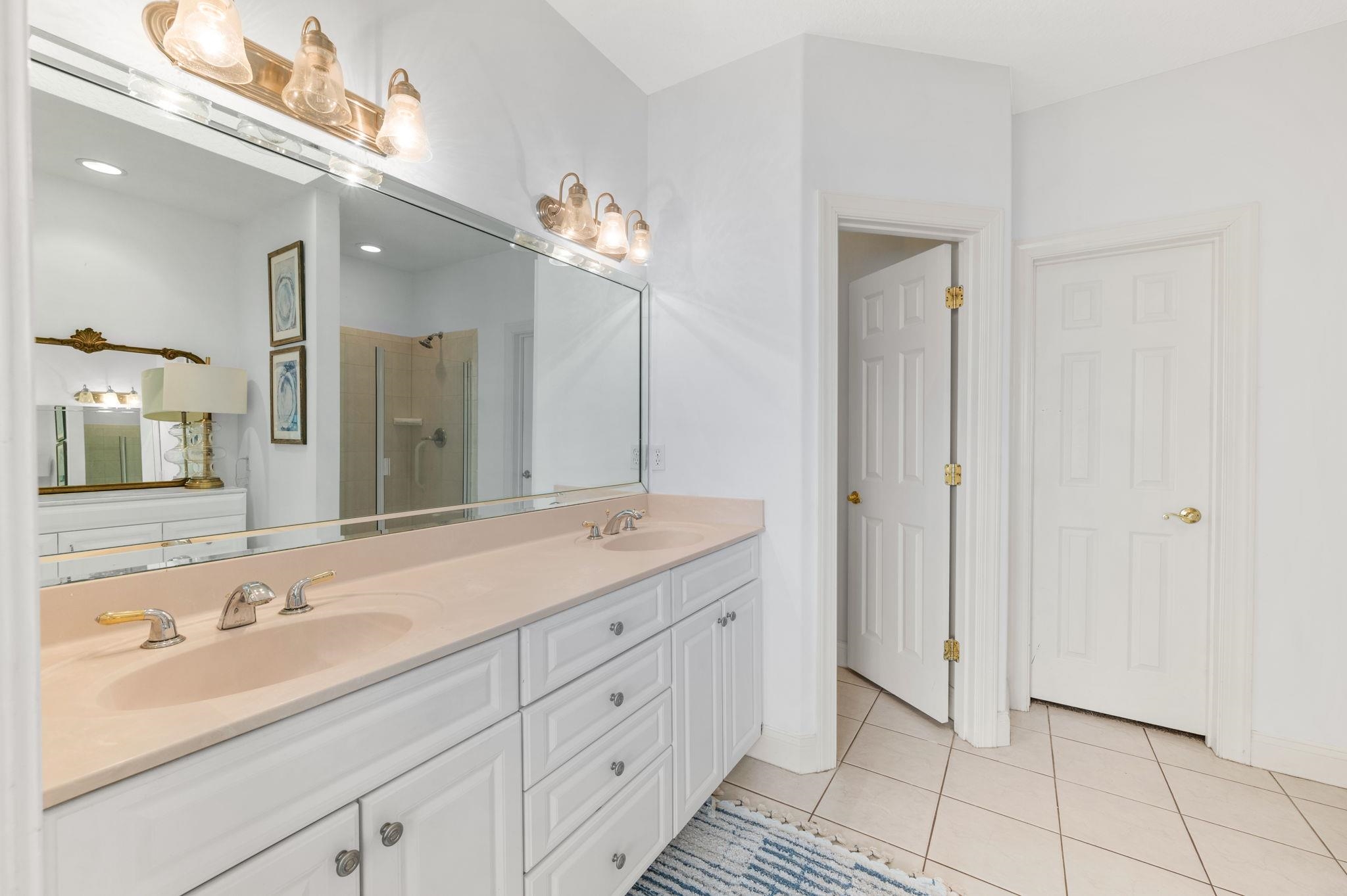 178 Sunset Circle North St. Augustine, FL 32080 - Photo 19 of 45 a bathroom with a double vanity sink and a mirror