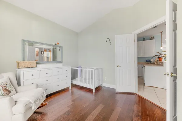 a bedroom with furniture and wooden floor