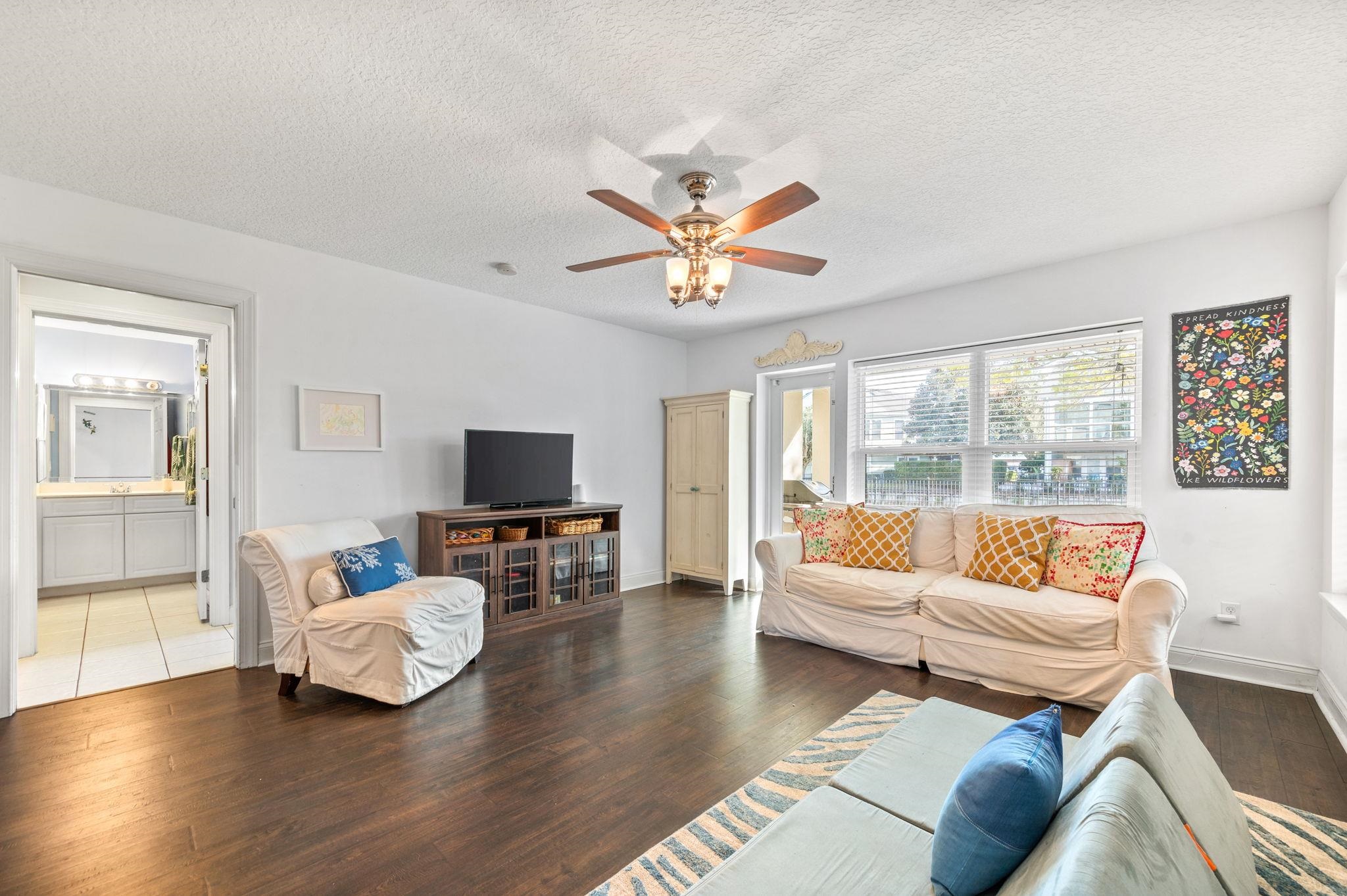 178 Sunset Circle North St. Augustine, FL 32080 - Photo 30 of 45 a living room with furniture and a flat screen tv with wooden floor