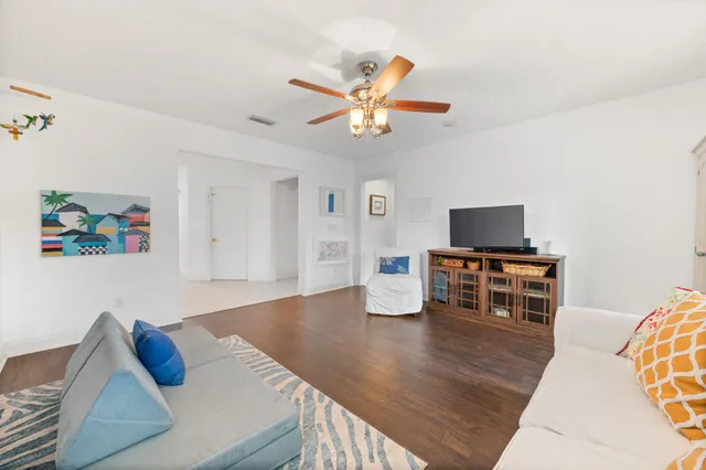a living room with furniture and flat screen tv