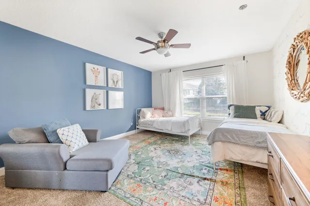 a bedroom with a bed couch and window